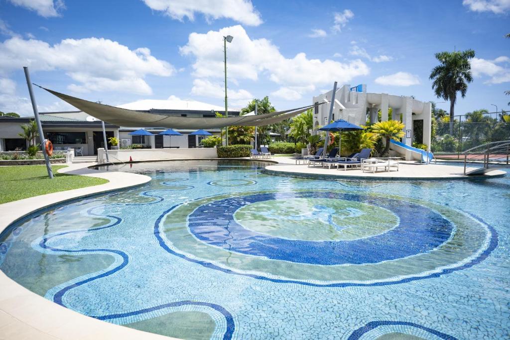 a swimming pool in a resort with a building at Fiji Gateway Hotel in Nadi