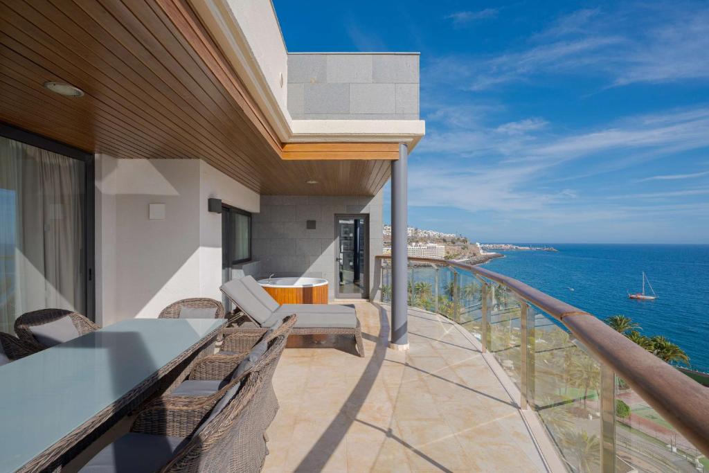 a balcony of a house with a view of the ocean at Radisson Blu Resort Gran Canaria in La Playa de Arguineguín