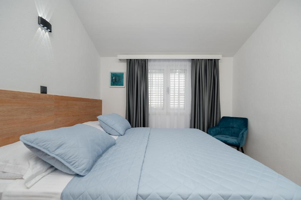 Posteľ alebo postele v izbe v ubytovaní Apartments Kudelik