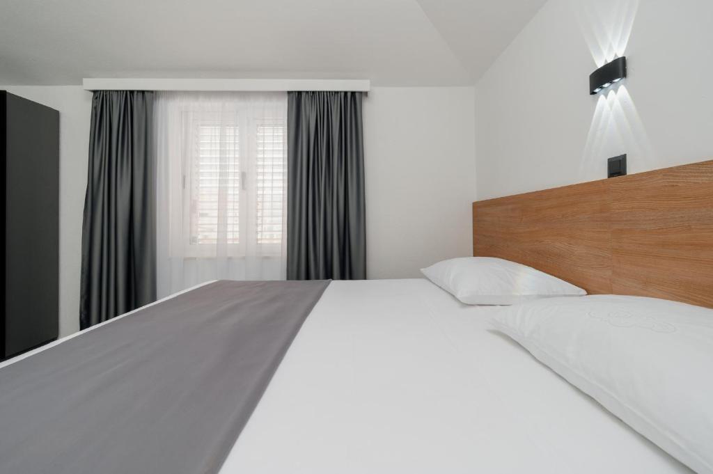 Posteľ alebo postele v izbe v ubytovaní Apartments Kudelik