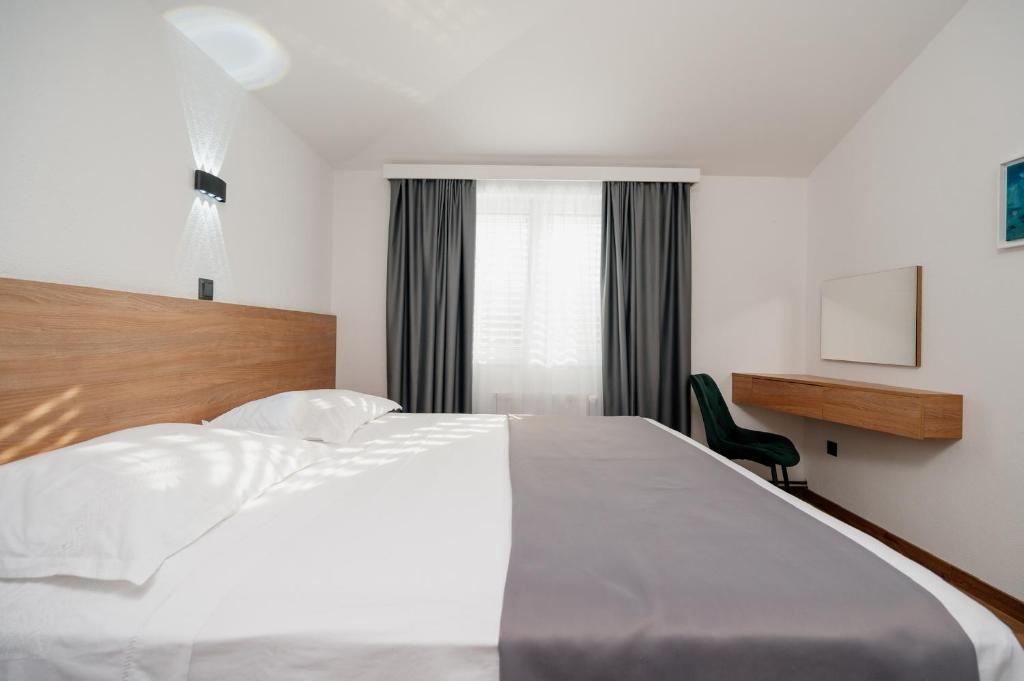Posteľ alebo postele v izbe v ubytovaní Apartments Kudelik