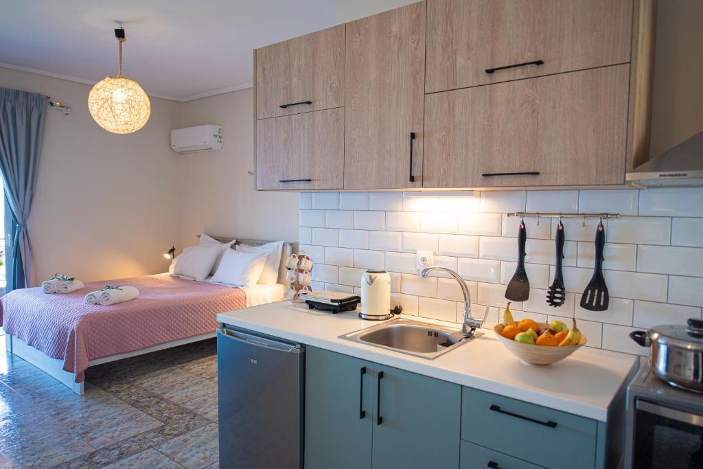 a kitchen with a sink and a bed in a room at Agnantio in Agios Nikitas