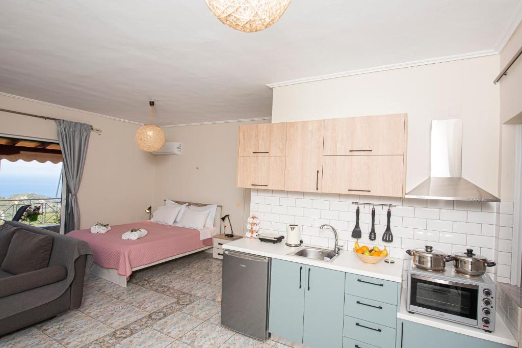a kitchen with a couch and a bed in a room at Agnantio in Agios Nikitas