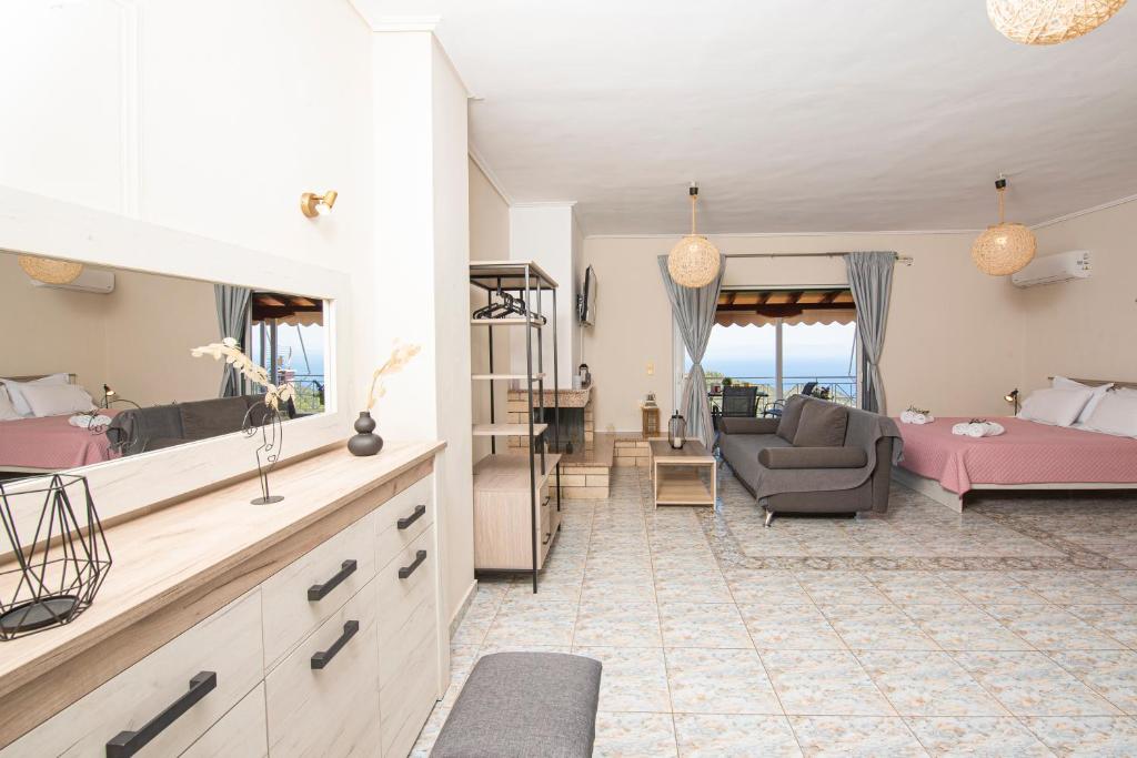 a living room with a bed and a couch at Agnantio in Agios Nikitas