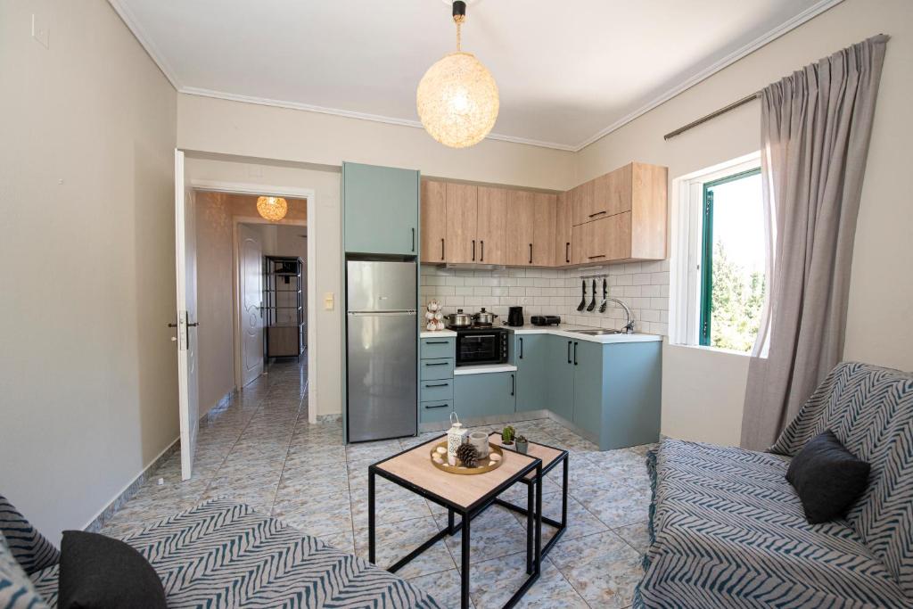 a kitchen and a living room with a table at Agnantio in Agios Nikitas
