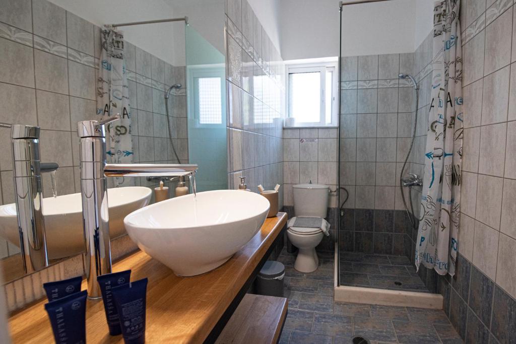 a bathroom with a large white sink and a toilet at Agnantio in Agios Nikitas