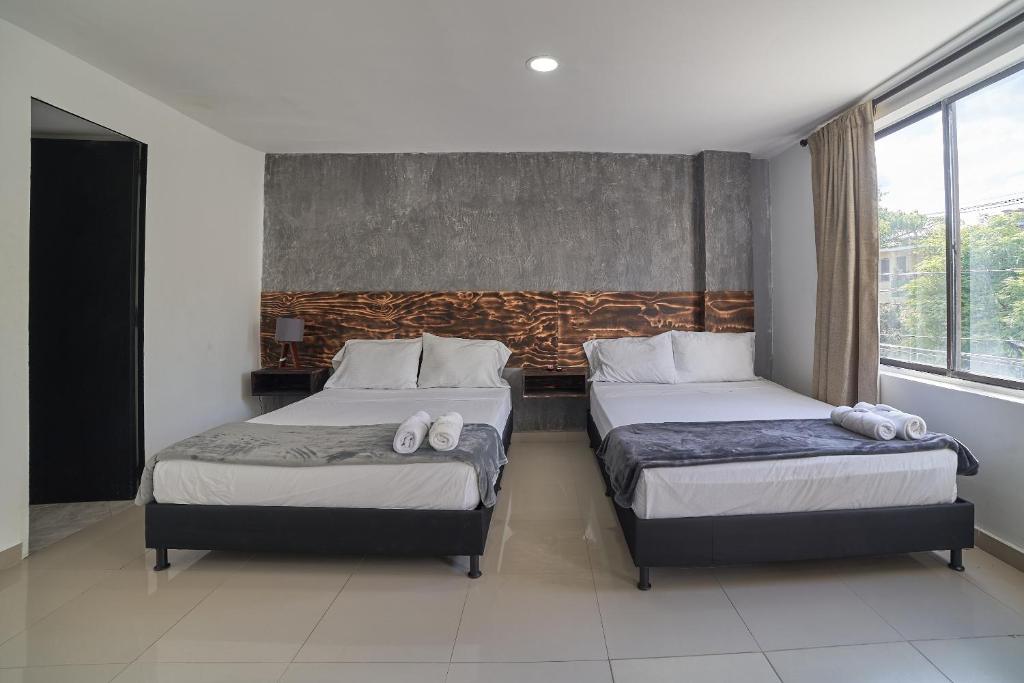 Postel nebo postele na pokoji v ubytování Hotel Express Medellin FARUM