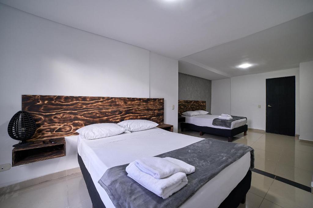 Postel nebo postele na pokoji v ubytování Hotel Express Medellin FARUM