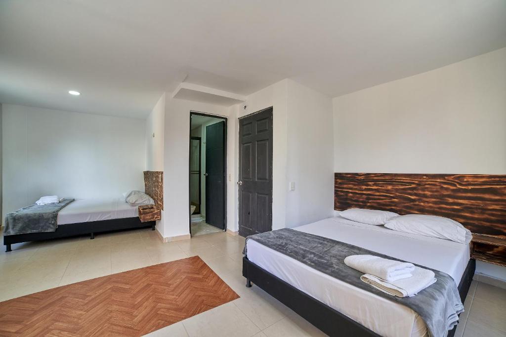 Postel nebo postele na pokoji v ubytování Hotel Express Medellin FARUM