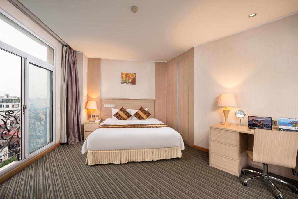 Postel nebo postele na pokoji v ubytování Super Candle Hotel