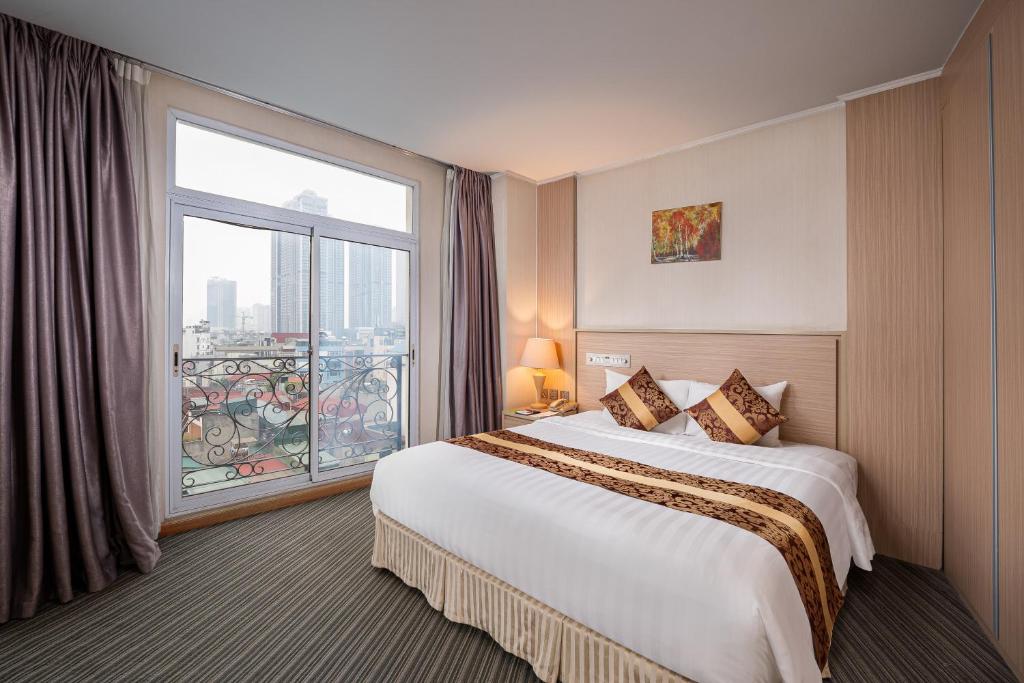 Postel nebo postele na pokoji v ubytování Super Candle Hotel
