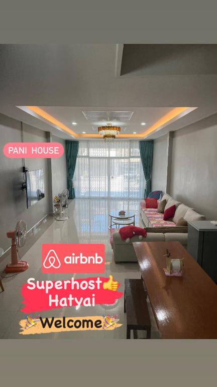 a living room with a couch and a table at Pani House ( Hatyai 3 ) in Hat Yai