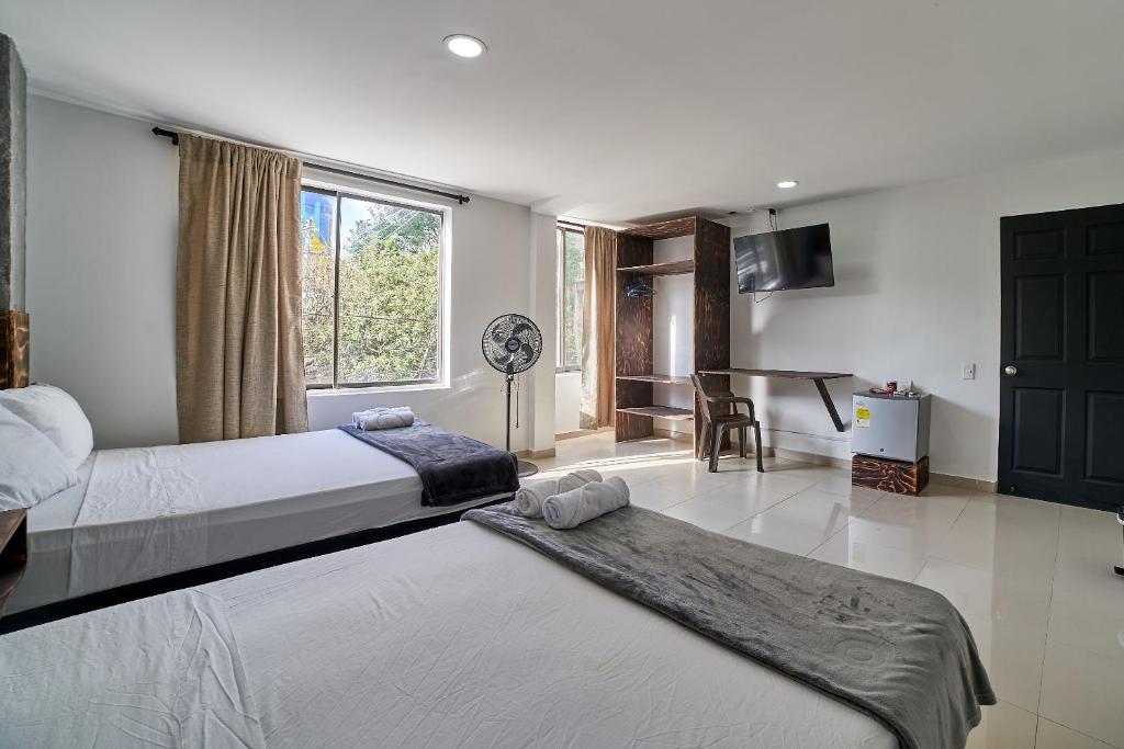 Postel nebo postele na pokoji v ubytování Hotel Express Medellin FARUM