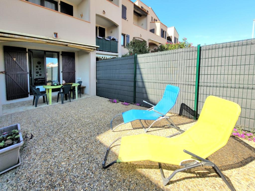 deux chaises et une table sur une terrasse dans l'établissement Studio Cabine Moderne RDC, Terrasse, Parking, Proche Mer, 500m Plage, 4 Pers, Animaux OK - FR-1-794-140, à Canet