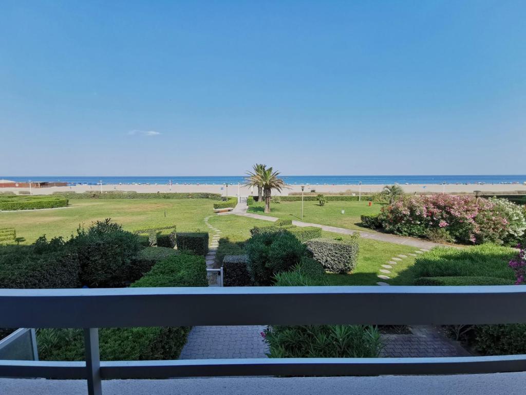 une vue sur un jardin depuis un balcon avec la plage dans l'établissement Canet-en-Roussillon - Studio cabine 4/5 pers - bord de mer avec parking - FR-1-794-144, à Canet