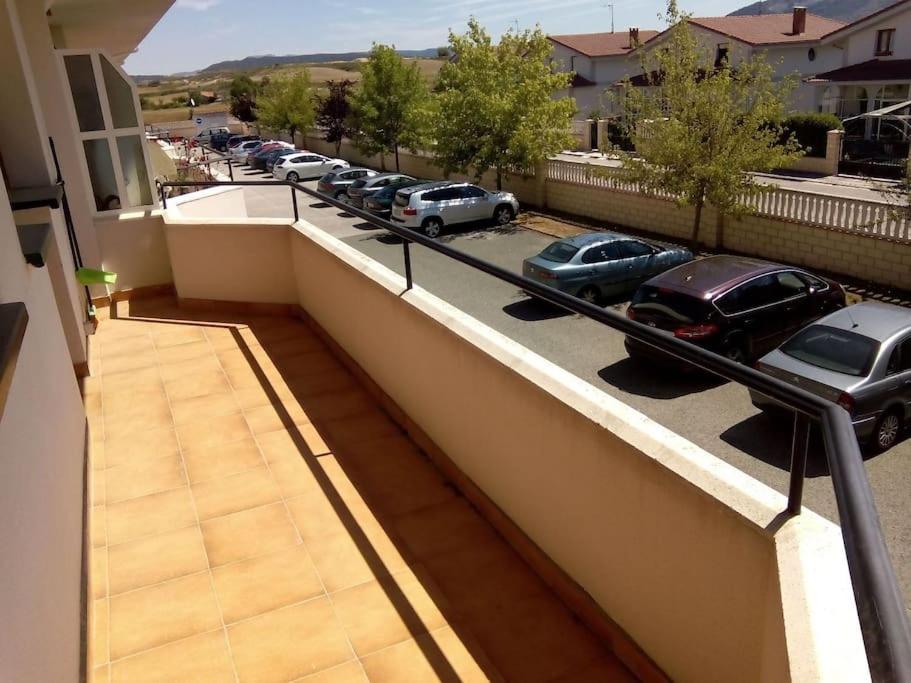 a balcony with cars parked in a parking lot at Apartamento con piscina privada No mascotas in Medina de Pomar