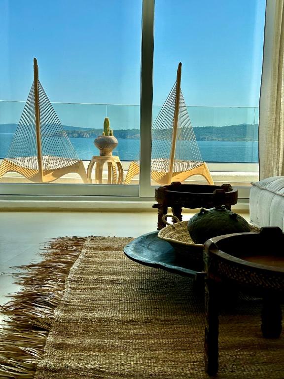 a room with a large window with a view of the ocean at Casa de oro Lujo in Sozopol