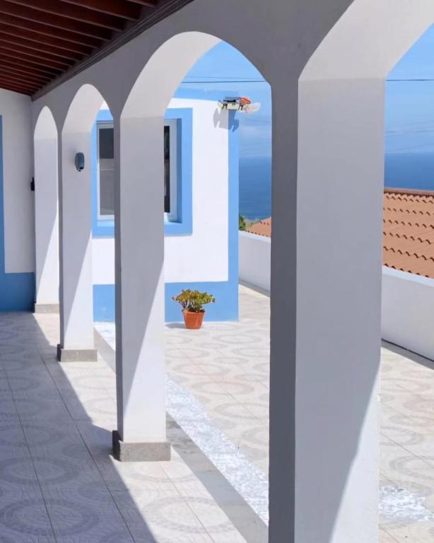 a hallway with blue and white buildings and the ocean at Oceanview Sunset Retreat in Pilar