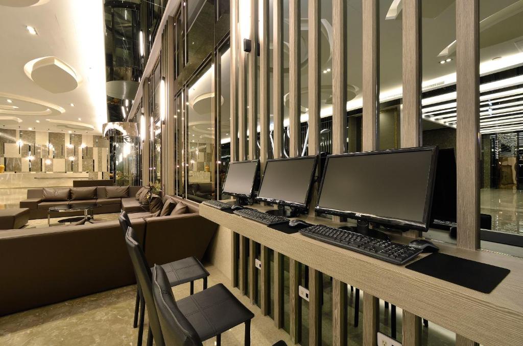 a row of computer monitors on a desk in a building at Tsun Huang Hotel in Chiayi City