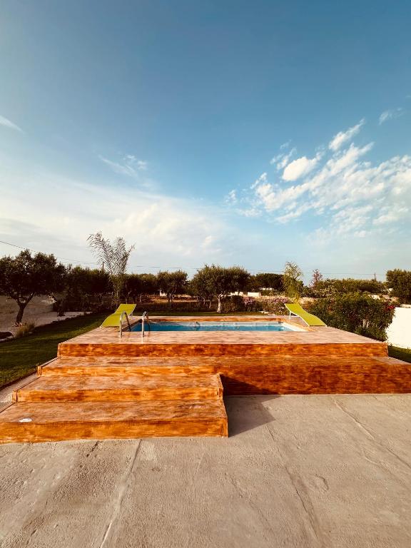 a wooden skateboard ramp in front of a swimming pool at Villa Santo Stefano in Monopoli