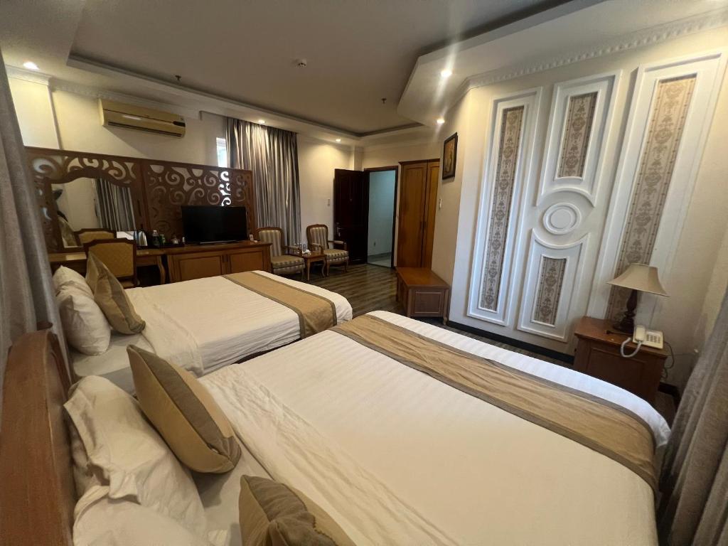 Postel nebo postele na pokoji v ubytování Madella Hotel