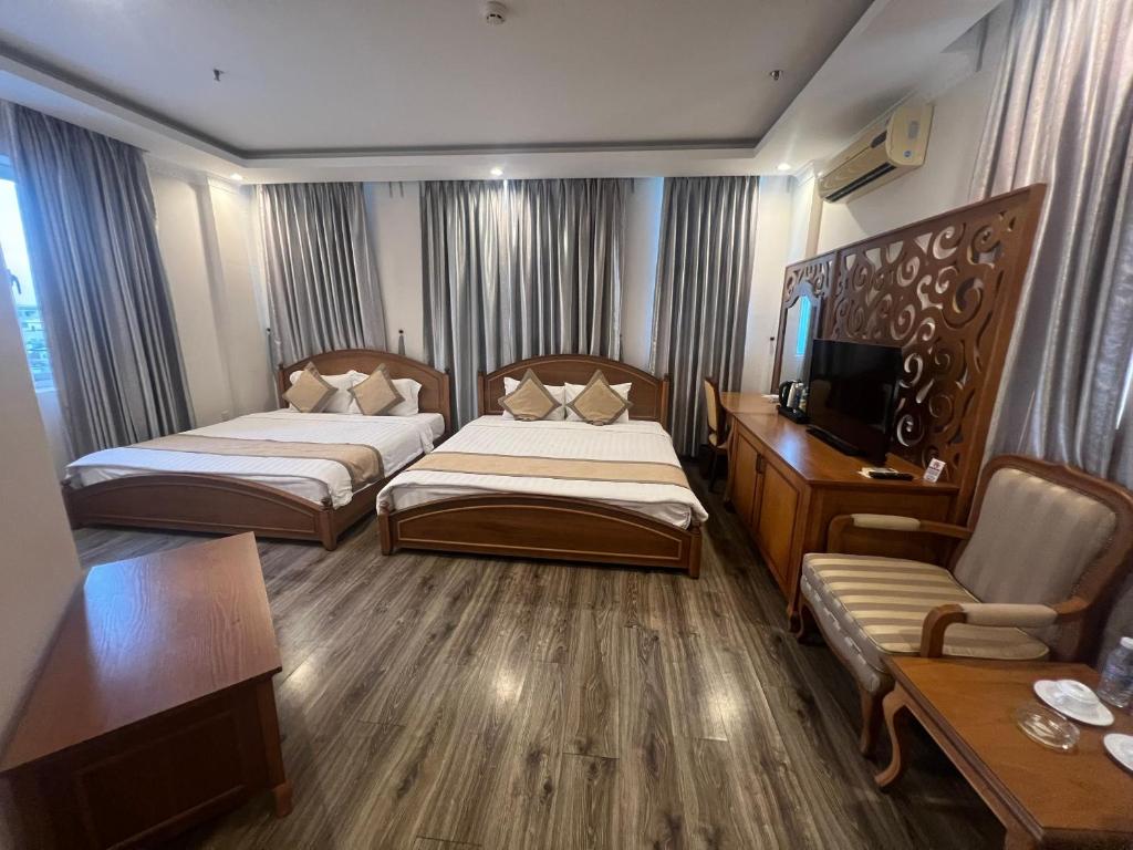 Postel nebo postele na pokoji v ubytování Madella Hotel