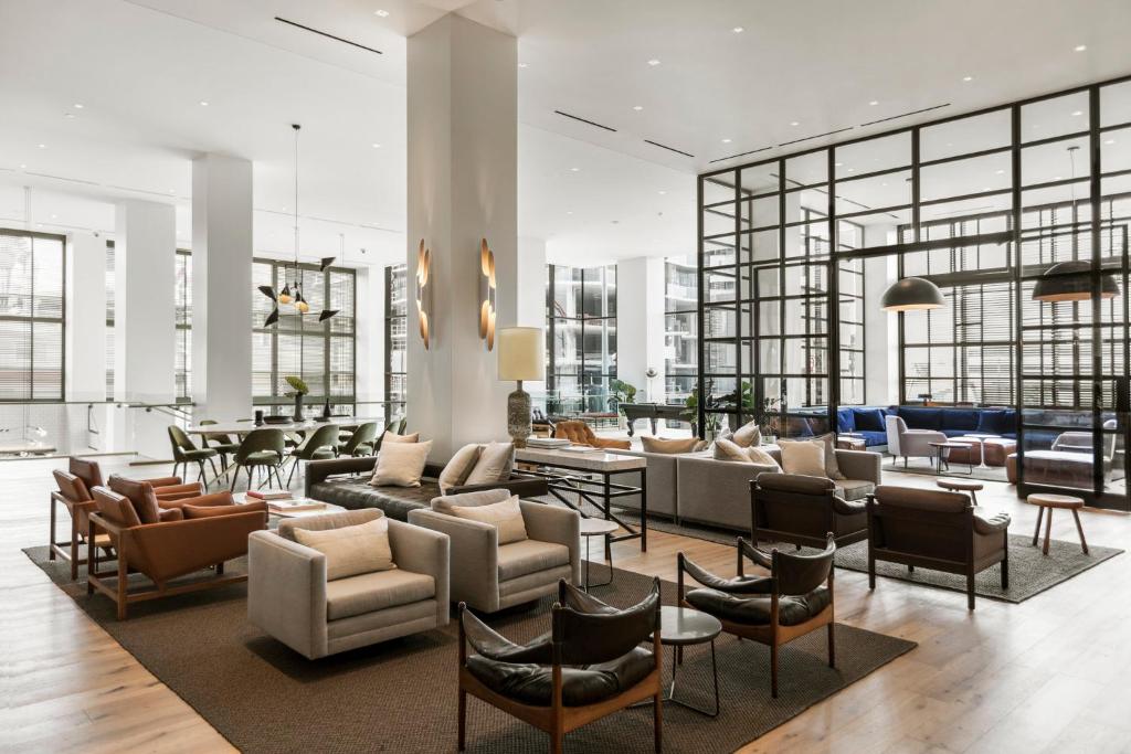 a lobby with a lot of chairs and tables at Kimpton Everly Hotel Hollywood, an IHG Hotel in Los Angeles