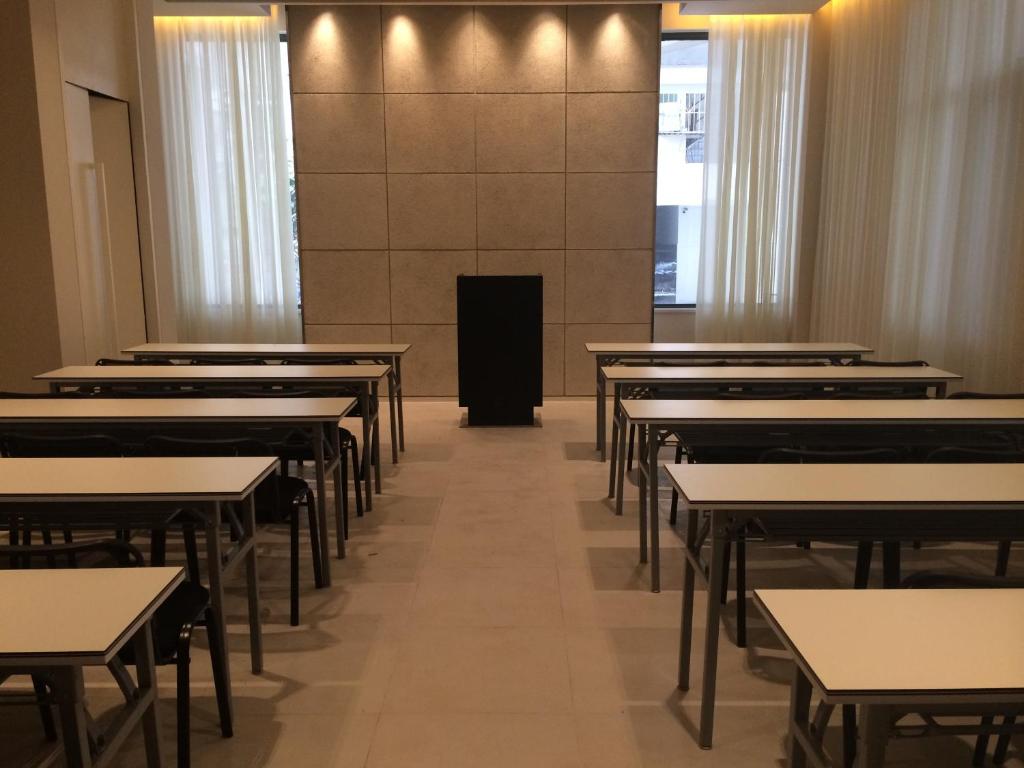 an empty classroom with rows of tables and chairs at Jinjiang Inn Yibin Zhongshan Street in Yibin