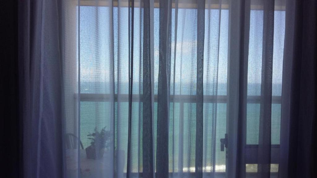 a view of a window with curtains on it at Residencial Green Diamond in Vila Velha