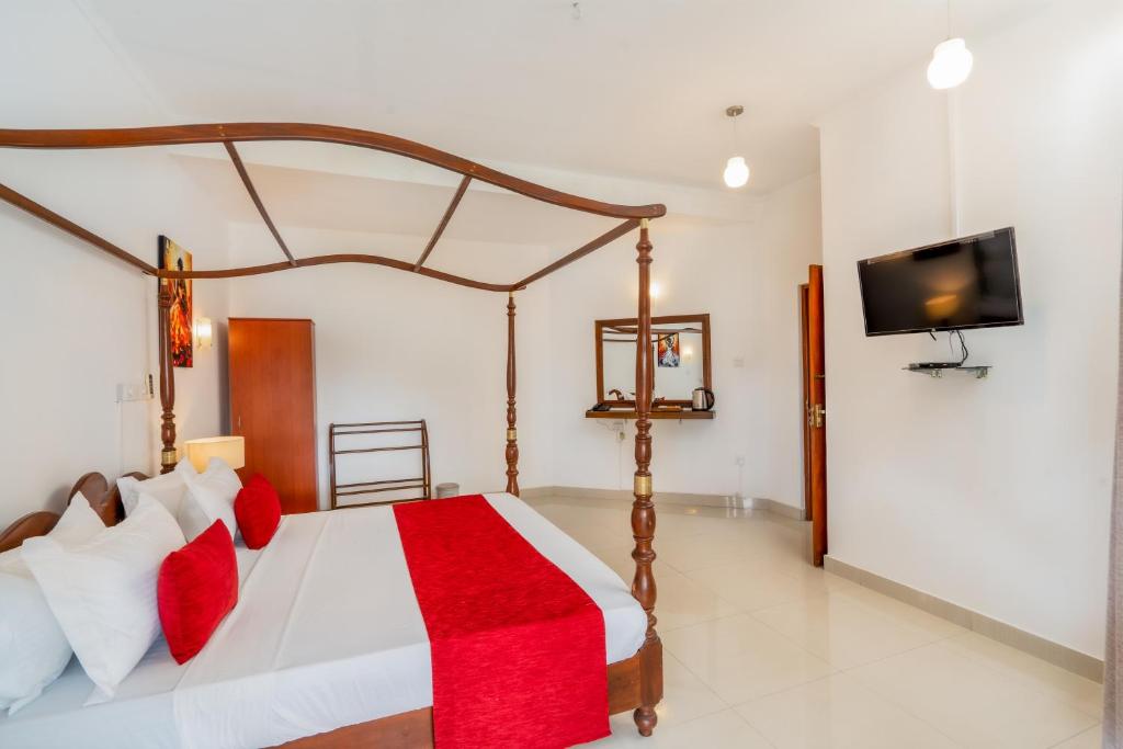 Postel nebo postele na pokoji v ubytování Kandy City Oasis Hotel
