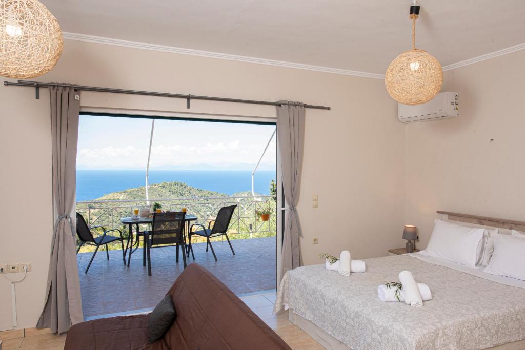 a bedroom with a view of the ocean at Agnantio in Agios Nikitas