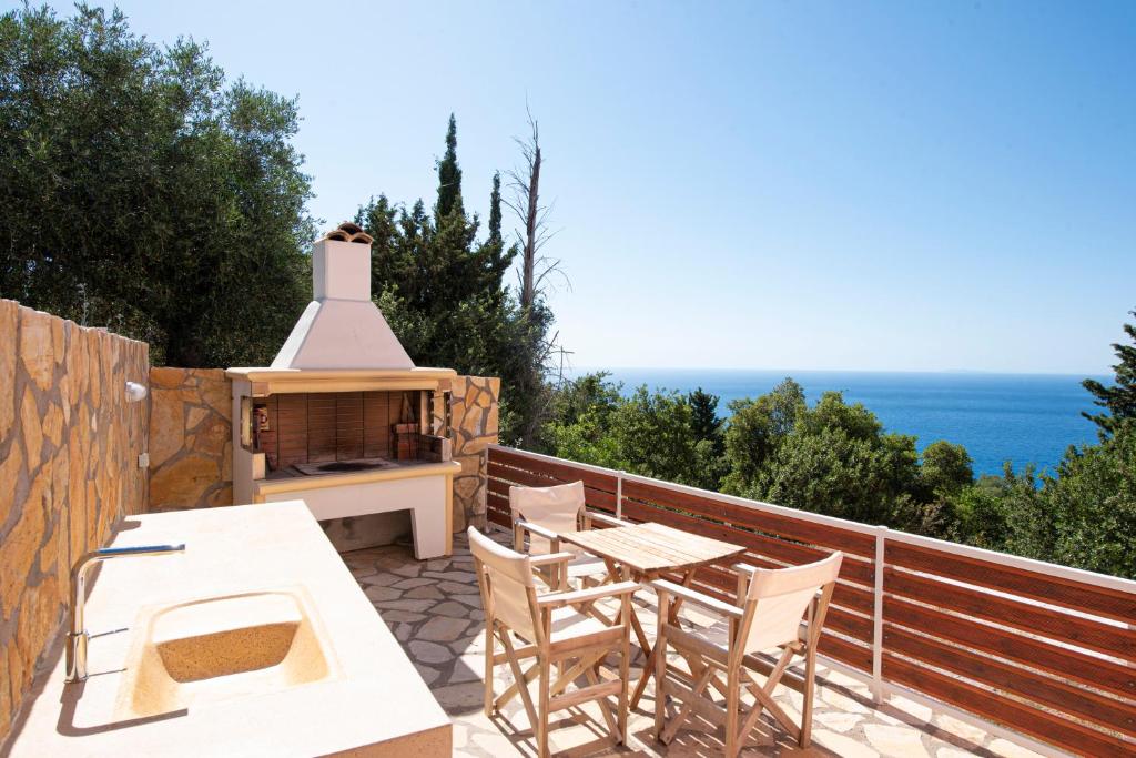 a patio with a table and chairs and a stove at Agnantio in Agios Nikitas