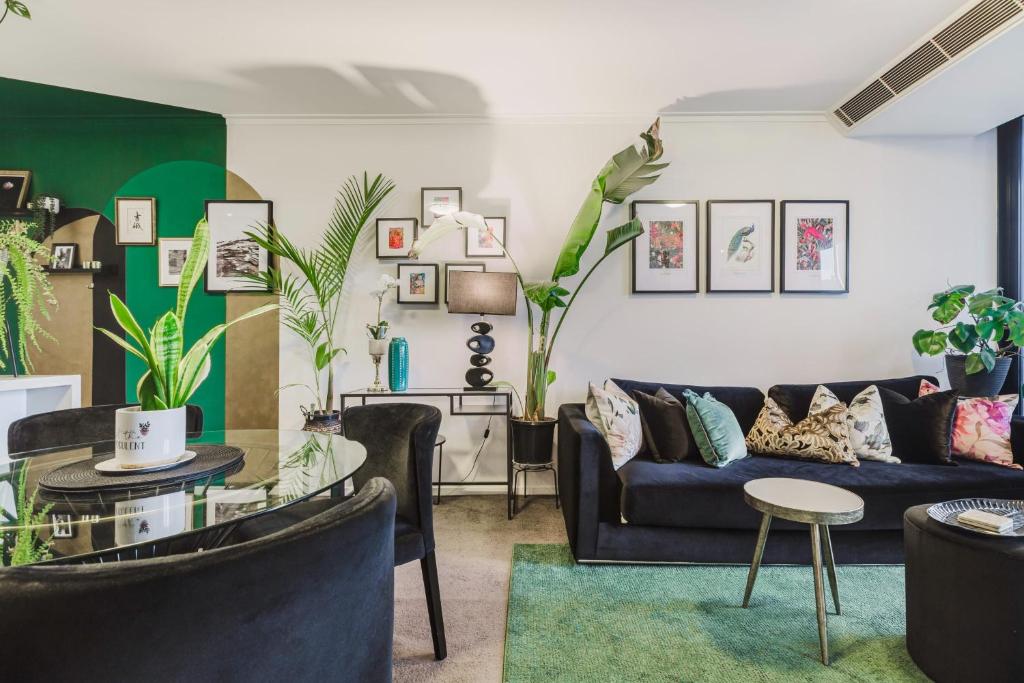 a living room with a couch and a table at VAQUAY Ambrosia In Southbank in Melbourne