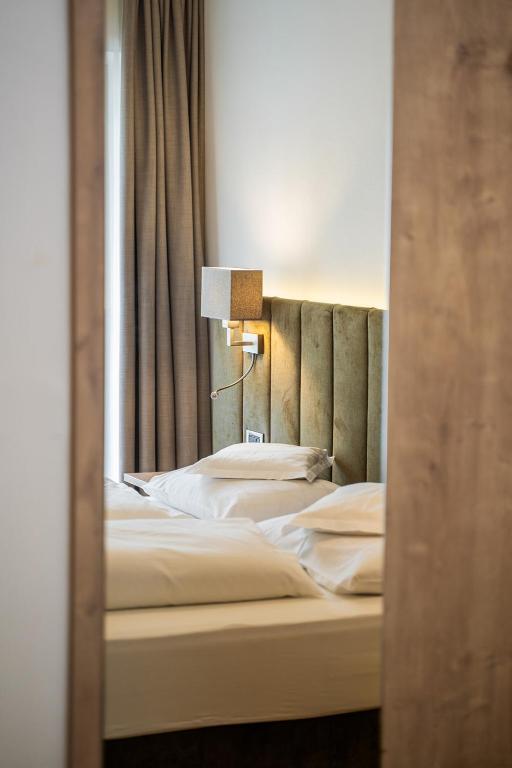 Postel nebo postele na pokoji v ubytování Hotel Brunnhofer