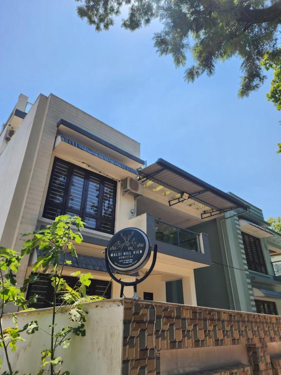 a building with a sign in front of it at Malsi Hill View Homestays in Dehradun