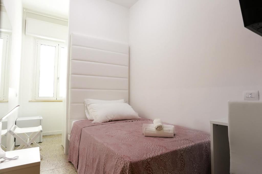 Postel nebo postele na pokoji v ubytování Hotel Ninfea Cattolica