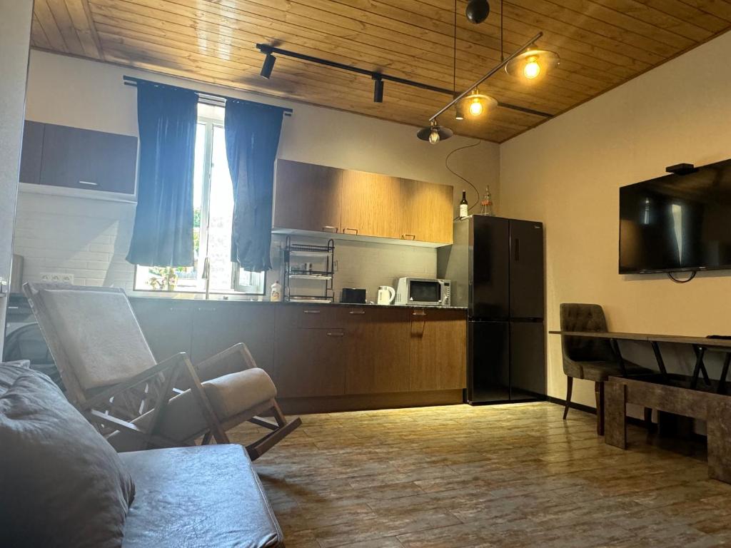 a kitchen with a couch and a table and a refrigerator at Old corner in Akhaltsikhe