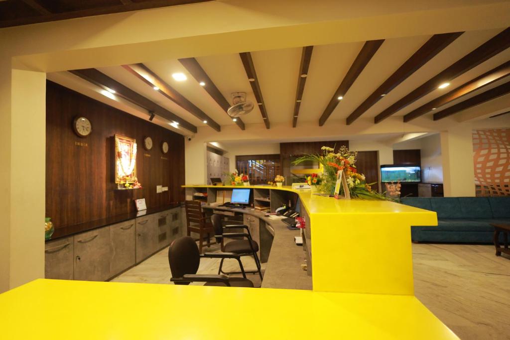 a yellow bar in a restaurant with a yellow counter at Soundarya Hotel in Bangalore