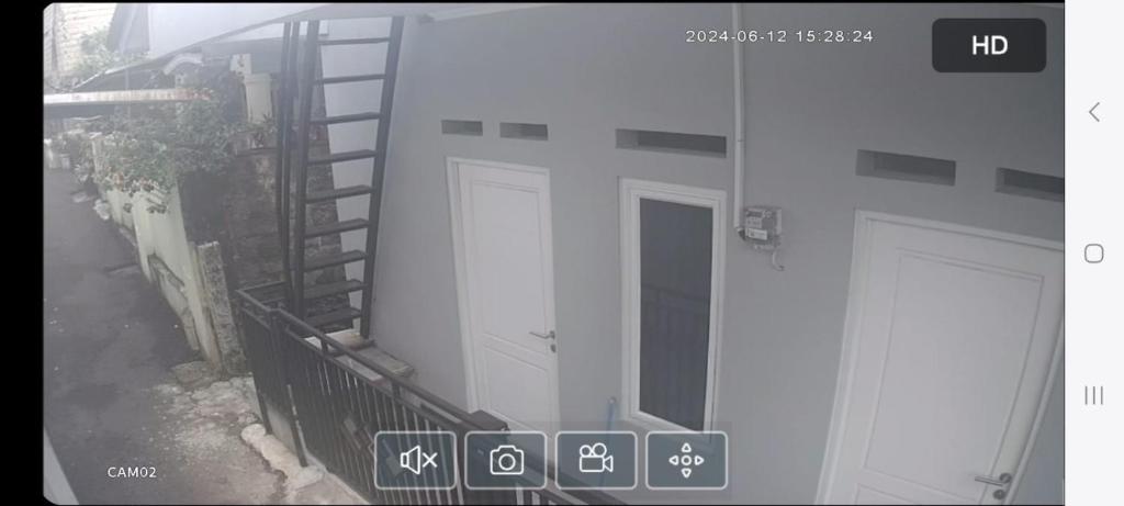 a view of a building with a white door and stairs at Gang DURIAN 39 in Jakarta