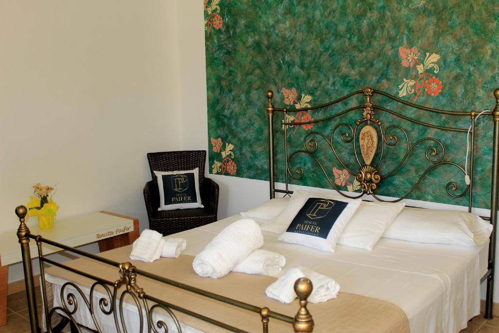 a bedroom with a bed with towels on it at Tenuta Paifer in Otranto