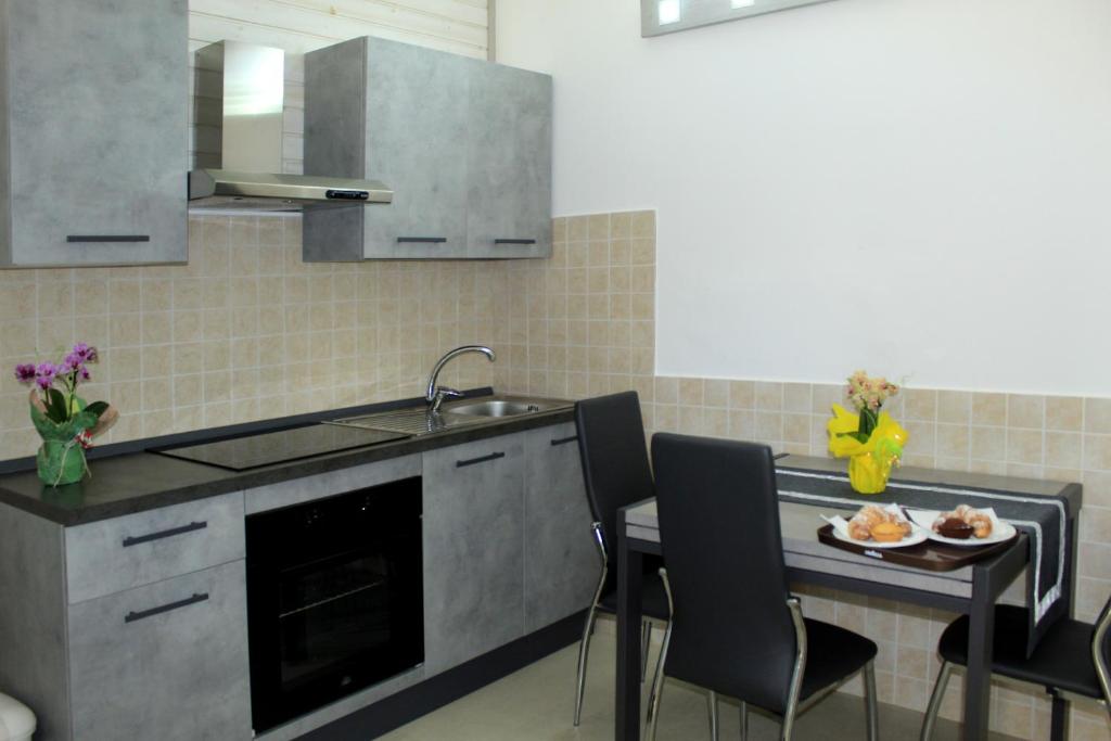 a kitchen with a sink and a table with a plate of food at Tenuta Paifer in Otranto