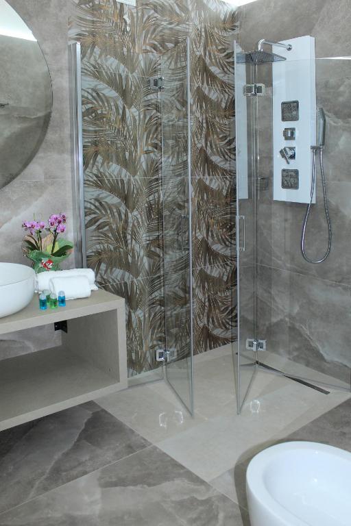 a bathroom with a shower and a toilet and a sink at Tenuta Paifer in Otranto