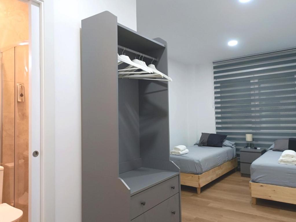 A bed or beds in a room at Casa de Huéspedes 12 Octubre Rooms