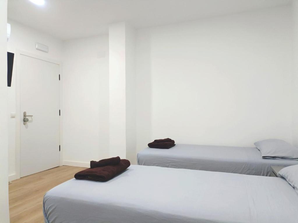 A bed or beds in a room at Casa de Huéspedes 12 Octubre Rooms