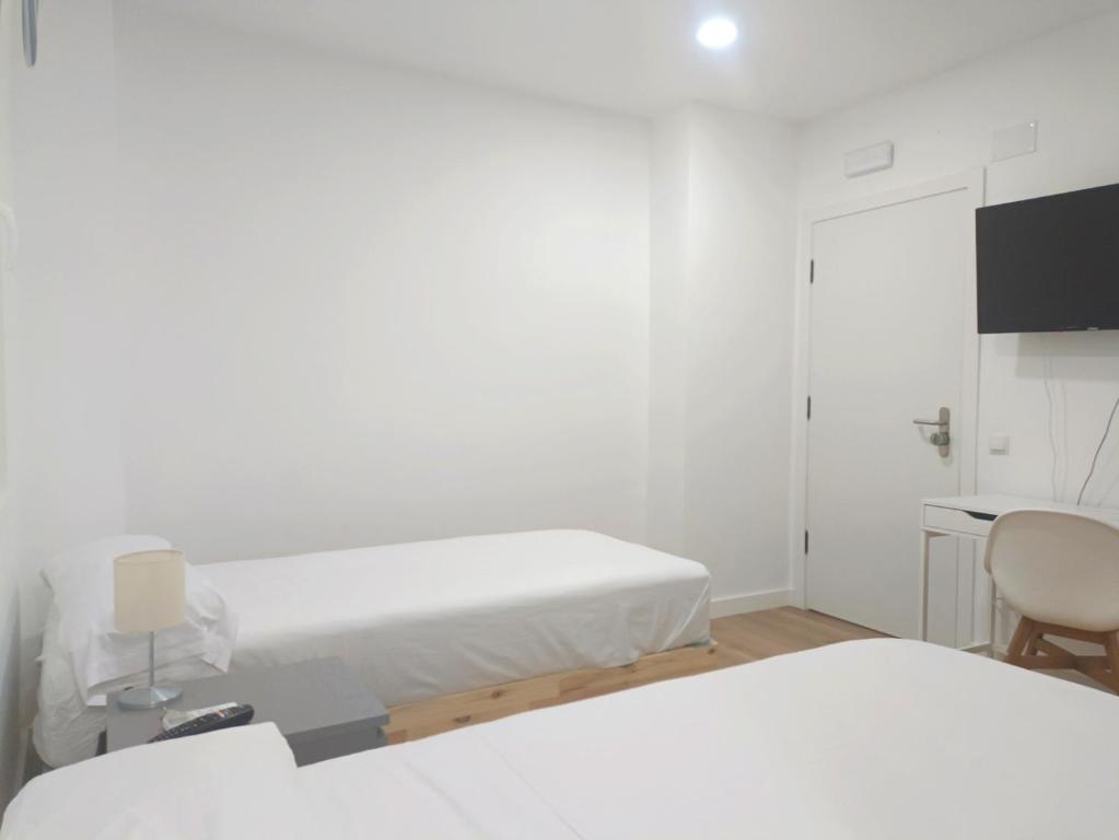 A bed or beds in a room at Casa de Huéspedes 12 Octubre Rooms
