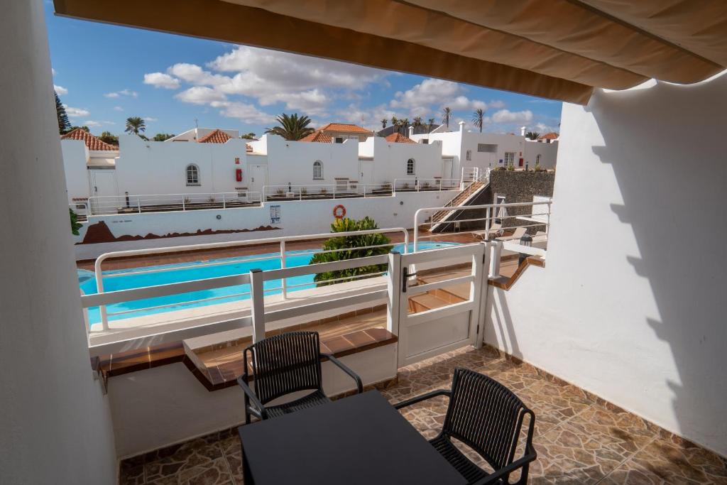 a view from the balcony of a villa with a swimming pool at Las Casitas de Corralejo in Corralejo