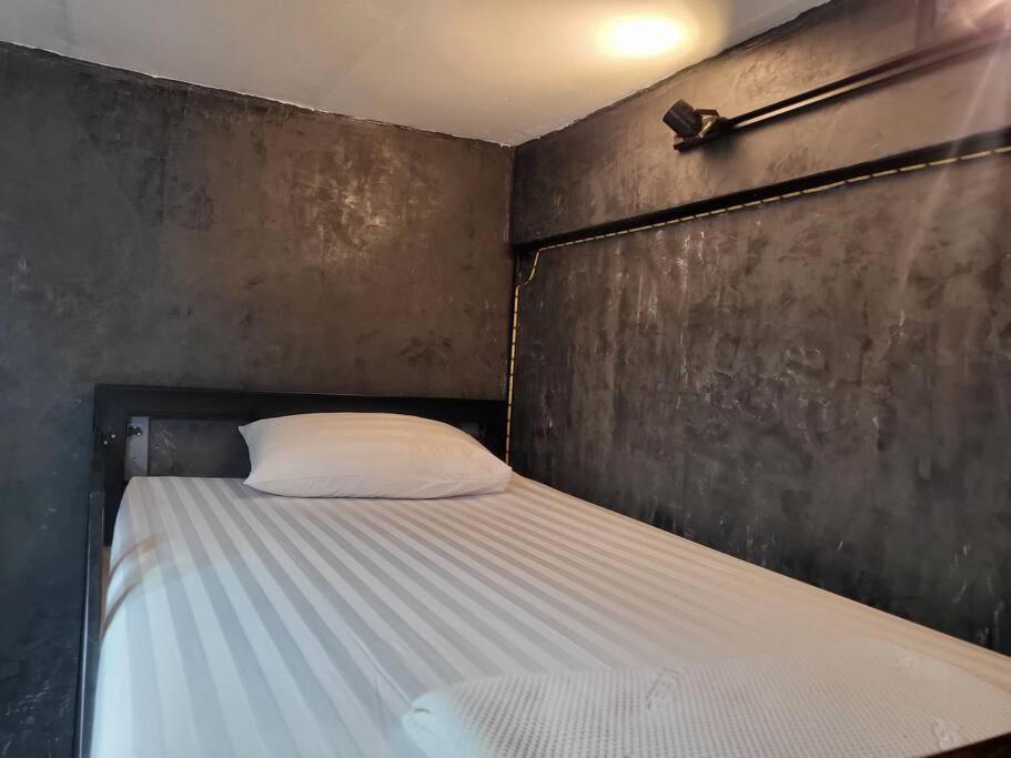 a bed with a white pillow in a room at auntythong house in Bangkok