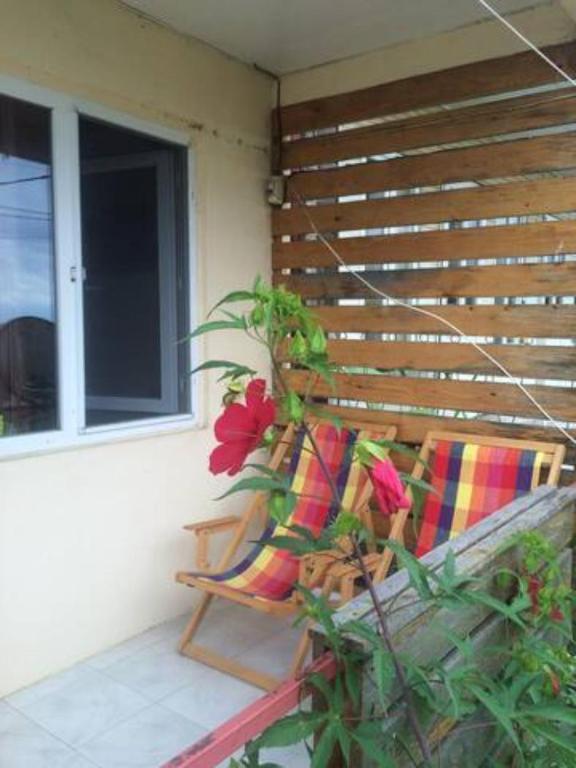 a pair of chairs sitting on a porch next to a window at Villa TaLi Beach in Maltakva