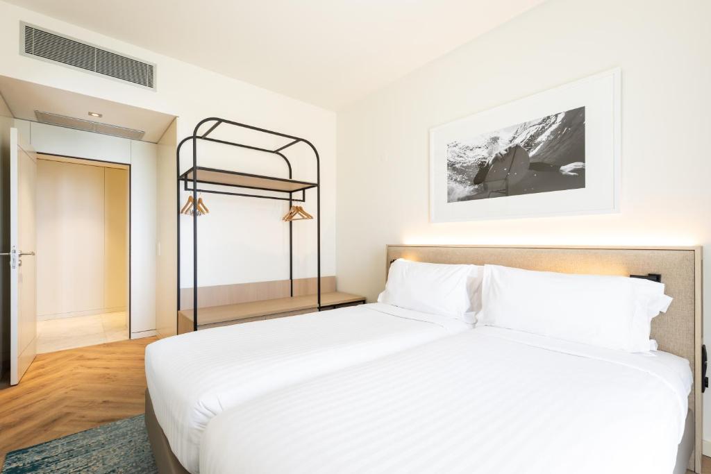 a bedroom with a bed and a bunk bed at Crowne Plaza - Caparica Lisbon in Costa da Caparica