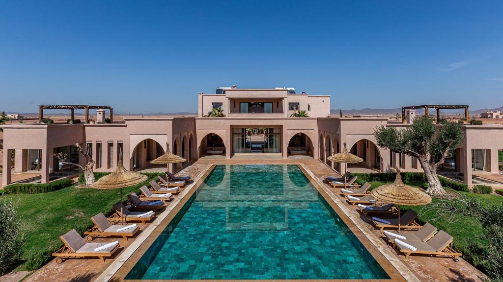 an image of a villa with a swimming pool and chairs at Luxury Villa Rêve D'ahlam à MARRAKECH in Oulad Boudene